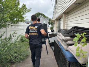 Junk removal experts carrying furniture.