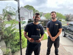 Junk removal experts at the door of a friendly customer.